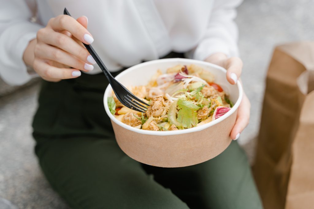 woman manicure eating salad